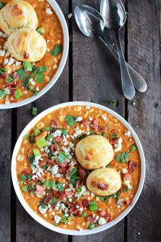 two bowls filled with soup on top of a wooden table