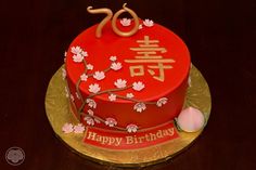 a red birthday cake with white flowers on it