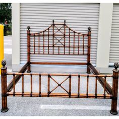 a wooden bed frame sitting next to a yellow fire hydrant