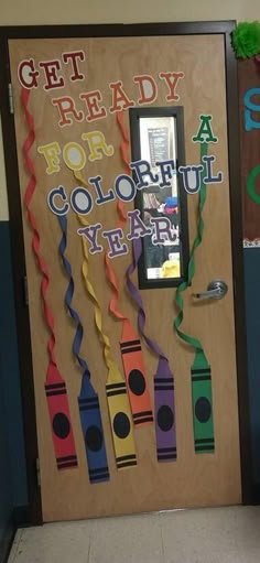 a classroom door decorated with colorful streamers and writing that says get ready for colorful year