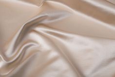 a close up view of a white satin fabric