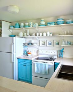 a white refrigerator freezer sitting inside of a kitchen next to a stove top oven