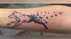 a tattoo on the arm of a woman with a wolf and butterflies flying around her