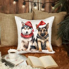 two dogs wearing hats and scarfs are sitting on a couch next to an open book