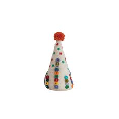 a white party hat with colorful buttons and pom poms on it's top