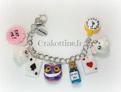 a charm bracelet with charms on it that include an owl, cat, and other items