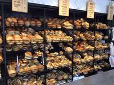 a bakery filled with lots of different types of breads and pastries on display