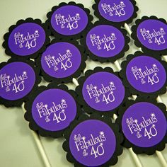 purple and black tags with the words fabulous 40 in white lettering on them are displayed for sale