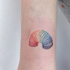 a woman's arm with a colorful tattoo on it