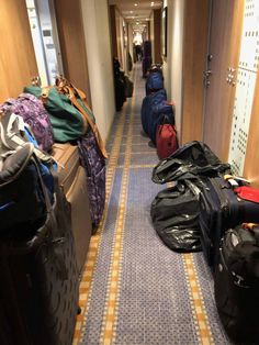 several suitcases are lined up along the hallway