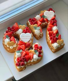 heart shaped cookies decorated with strawberries and other toppings