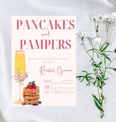 pancakes and pampers party card with flowers on the table next to eachother