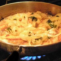 a pan filled with pasta on top of a stove