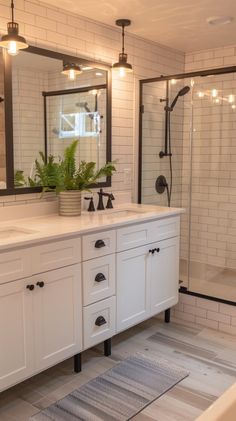 a large bathroom with white cabinets and black trim on the shower door, sink, and bathtub