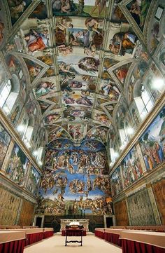 the ceiling is painted with many paintings