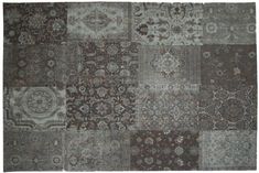 a patchwork rug with many different colors and patterns on the carpet, including brown, grey