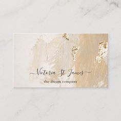 a business card with gold foil paint and the words victoria st james, the dream company