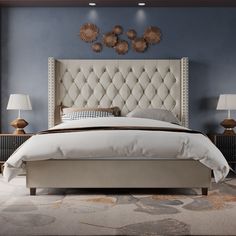 a large bed sitting next to two lamps on either side of the headboard and foot board