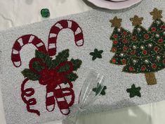 a place mat with candy canes and christmas decorations on it