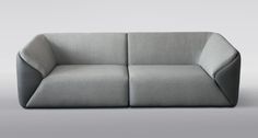 a gray couch sitting on top of a white floor