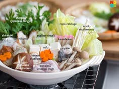 a white bowl filled with lots of different types of food on top of a stove