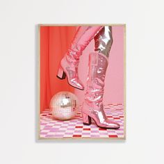 a woman's legs in high heeled boots next to a disco ball