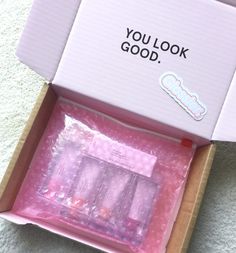 an open box with pink items in it