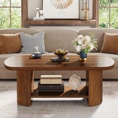 a living room with a couch, coffee table and pictures on the wall above it