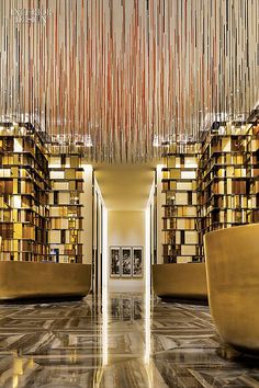 the interior of a modern library with bookshelves and chandeliers