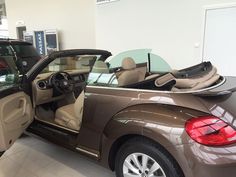 a car is parked in a showroom with its doors open