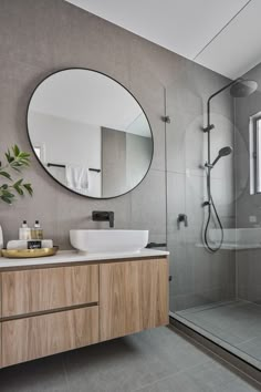 a bathroom with a sink, mirror and bathtub in the shower area is shown