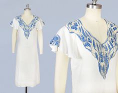 Wonderful circa 1930 dress in a super wearable lightweight breezy cotton. Features cornflower blue openwork embroidery in an Art Nouveau webby iris or lily motif. Short flutter sleeves, each with a triangular cutwork section featuring one large iris. Loose, forgiving, slightly flared silhouette. Perfect everyday, picnic, or garden party dress, or even casual bride! Measurements: *meant to fit loosely. no closures, slips over the head, so please allow extra room at waist. Recommended for a size S-M Bust: 36" Waist: 32" Hip: 38" Length: 42" Condition: Excellent. Some faint discoloration spots on side of left flutter sleeve, near hem. @guermantes.vintage www.guermantesvintage.com White Cotton Summer Dress, 1930 Dress, Casual Bride, 20s Dresses, Cotton Summer Dress, Sax Dress, Printed Gowns, Moroccan Dress, Garden Party Dress