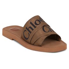 Description The Chloe Woody Logo Slide In Grove Brown Is A Slip-On Style Flat And Features The Iconic Chlo Logo Centrally Printed On The Ribbon Strap. Fabrication: 100% Polypropylene Chic Brown Round Toe Slides, Chic Brown Slides With Round Toe, Designer Brown Slides For Spring, Chic Brown Slides With Leather Footbed, Chic Brown Slides With Leather Sole, Designer Brown Sandals For Spring, Bag And Shoes Closet, Chloe Brand, Chloe Logo