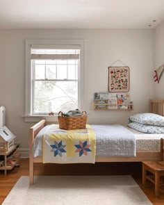 a bed room with a neatly made bed and a basket on top of the bed