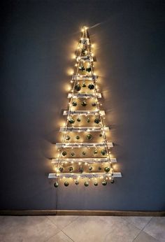 a christmas tree made out of lights on the wall