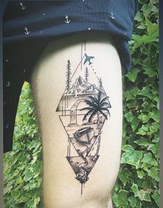 a man with a tattoo on his thigh that has an island and palm trees in it