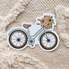 a sticker depicting a bicycle with sunflowers on the front and back wheel