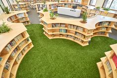 an aerial view of a library with many bookshelves and green carpeted flooring