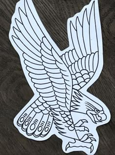 an eagle sticker sitting on top of a wooden table