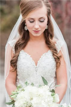 a woman in a wedding dress holding a bouquet