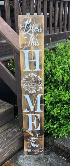 a wooden sign that says,'bless this home and the who enter it '