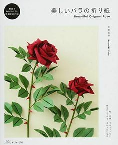 two red roses with green leaves are on the front cover of an origami book