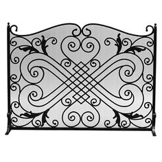 a wrought iron fireplace screen with scroll designs