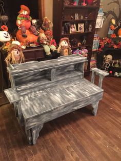 an old piano sitting on top of a hard wood floor next to a book shelf