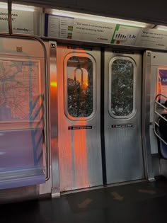 an empty subway car with two doors and the door is open to let people know where they are going