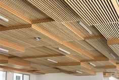 an empty room with wood slats on the ceiling