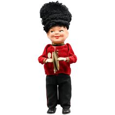 a toy doll wearing a red jacket and black pants