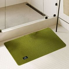 a bathroom with a green rug on the floor