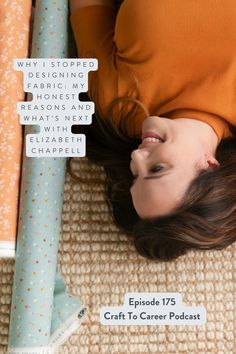 a woman laying on the floor next to some wrapping paper