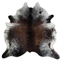 a brown and white cowhide rug on a white background